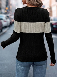 Close-up of slim fit knitted top with ribbed texture and two-tone color block back detail