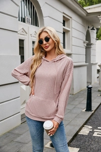 Detailed close-up of pink ribbed knit hoodie showing kangaroo pocket and texture