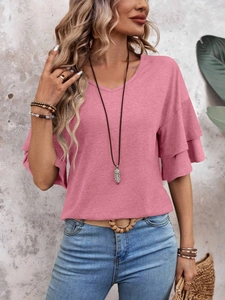 Detail of pink V-neck top showing double-layered ruffle sleeves and textured fabric