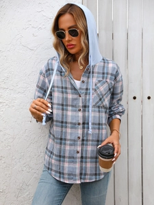 Detail of classic plaid shirt with contrasting light blue drawstring hoodie and front pocket