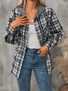 Detail of a casual oversized black and white plaid shirt with a grey jersey hood