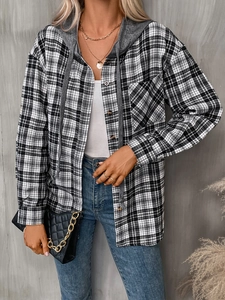 Detail of oversized black and white plaid hooded shirt with drawstring and chest pocket