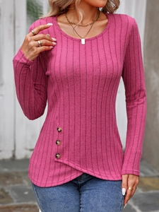 Detail of fuchsia ribbed knit top with crisscross hem and decorative brown buttons