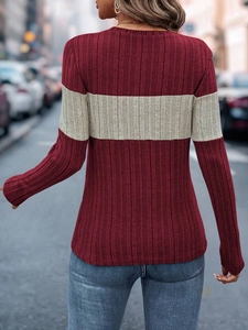 Close-up of the back view of a ribbed long sleeve color-block top in burgundy and grey