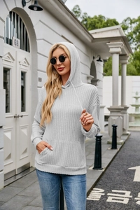 Detail view of light grey ribbed knit hoodie with kangaroo pocket and drawstring hood