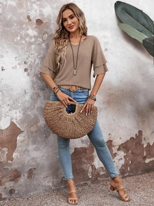 Close-up of V-neck casual top featuring layered ruffle sleeves and soft knit texture