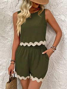 Close-up of olive green linen set with white scalloped lace edges on top and shorts