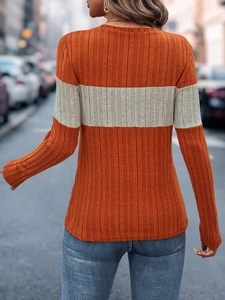 Macro shot of vertical ribbed knit texture on a long sleeve striped top for women
