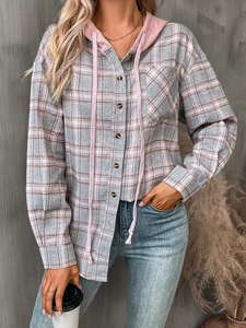 Detail of female oversize plaid shirt featuring pink hood, gray checkered pattern and buttons