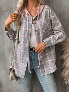 Detail view of pink and grey plaid oversized hoodie shirt with drawstring hood and pocket