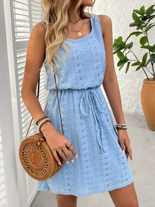 Detail of light blue sleeveless lace dress with geometric cutout patterns and drawstring