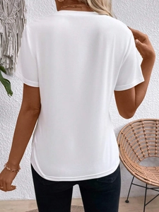 Back view of a loose white crewneck T-shirt showing soft fabric texture and draped hem