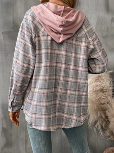 Detail view of women's oversize plaid shirt with pink hood and grey orange checkered pattern