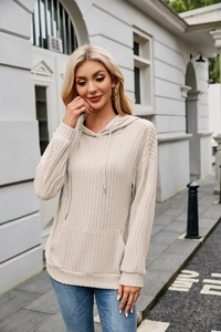 Detail of light beige ribbed knit hoodie featuring kangaroo pocket and drawstring hood