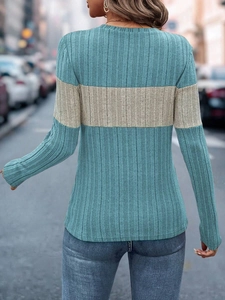 Back view of a casual long sleeve knit top featuring a navy blue and beige color block design