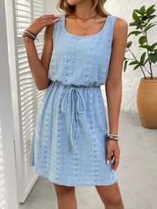 Close-up of light blue hollow lace dress with intricate geometric textures and waist drawstring