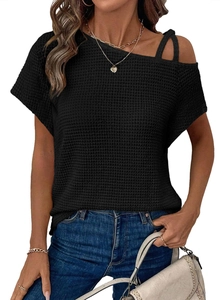Detail of black off-shoulder knit top with unique strap and waffle texture fabric