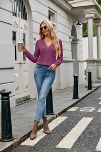 Close-up of a purple V-neck long-sleeve top with fine knit texture and slim fit design