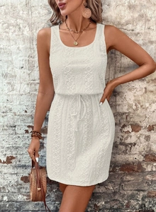 Detail of white crochet sleeveless dress featuring square neck and adjustable drawstring waist