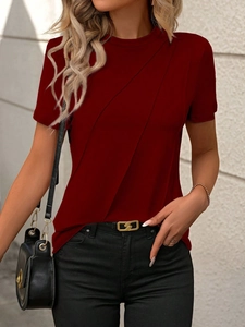 Close-up of wine red short sleeve top featuring elegant front diagonal pleated detailing