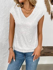 Détail du haut blanc à col en V avec sequins verticaux et texture de broderie scintillante