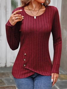 Detail of burgundy ribbed knit long sleeve top with asymmetric buttoned hem design