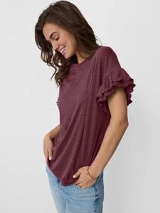 Detail of wine red t-shirt showing double-layered ruffled sleeves and soft fabric texture
