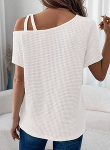 Macro detail of the white waffle knit fabric texture and stylish open shoulder strap design