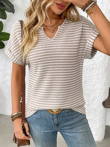 Detailed view of the V-neckline and textured striped knit fabric on a women's summer top