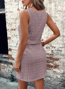 Macro shot of light purple geometric lace texture and floral patterns on the sleeveless dress