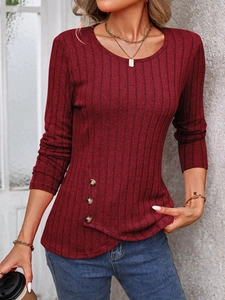 Detail of burgundy ribbed knit top featuring side buttons and crew neck texture