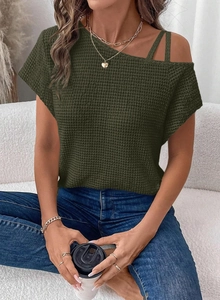 Detail of olive green waffle knit texture and asymmetric off-shoulder strap design