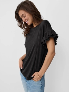 Close-up detail of double-layer ruffle sleeves on this black women's crew neck tee