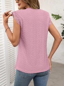 Close-up of pink crew neck T-shirt featuring delicate lace trim and hollow embroidery details