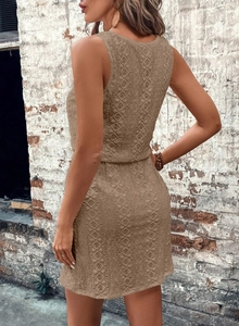 Close-up of khaki sleeveless dress featuring geometric hollow lace and drawstring waist detail