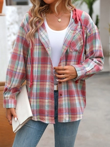 Detailed close-up of hooded plaid shirt featuring vintage patterns and pink drawstrings