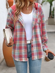 Detail of red and green plaid oversized hooded shirt with button front and chest pocket