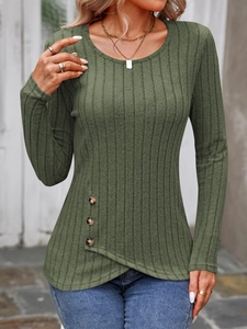 Close-up of ribbed dark green knit top with asymmetric crossover hem and side wood buttons