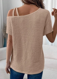 Detail of the unique waffle knit texture and cold-shoulder cutout design on back view