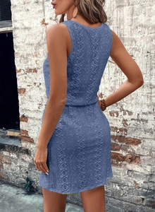 Detailed macro view of the intricate blue floral lace pattern and texture on the sleeveless dress
