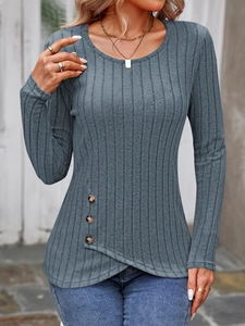 Detail of grey ribbed knit top featuring side button accents and crossover hem design