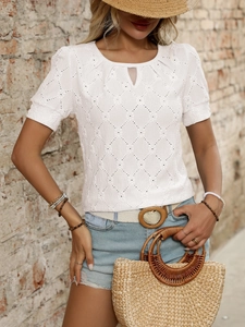 Close-up of white knit top featuring hollow diamond texture and neckline cutout detail