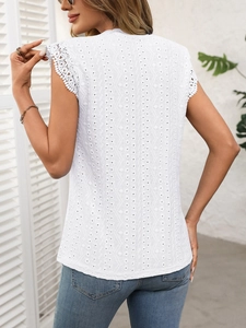 Rear view of white lace hollow-out top showing intricate embroidery and floral lace edges