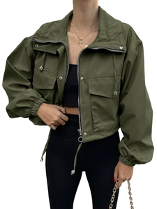 Detail of olive green windbreaker showing cargo pockets and metal zipper closure