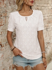 Detail of white hollow-out knit top showing diamond texture and lace patchwork mesh