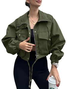 Close-up of military green windbreaker jacket with silver zipper and utility pockets