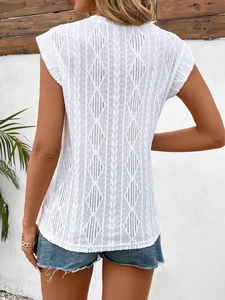 Close-up of the white knit hollow-out diamond pattern on the back of sleeveless summer top