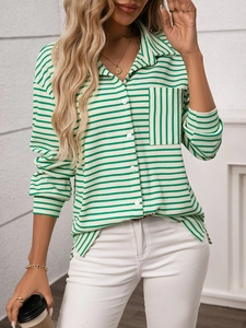 Detail of waffle knit fabric and striped pocket on green and white striped long sleeve shirt