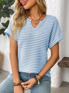 Close-up of the V-neckline and textured blue and white striped knit fabric on the top