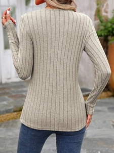 Detail shot of the vertical ribbed texture on a beige slim-fit long sleeve knitted top